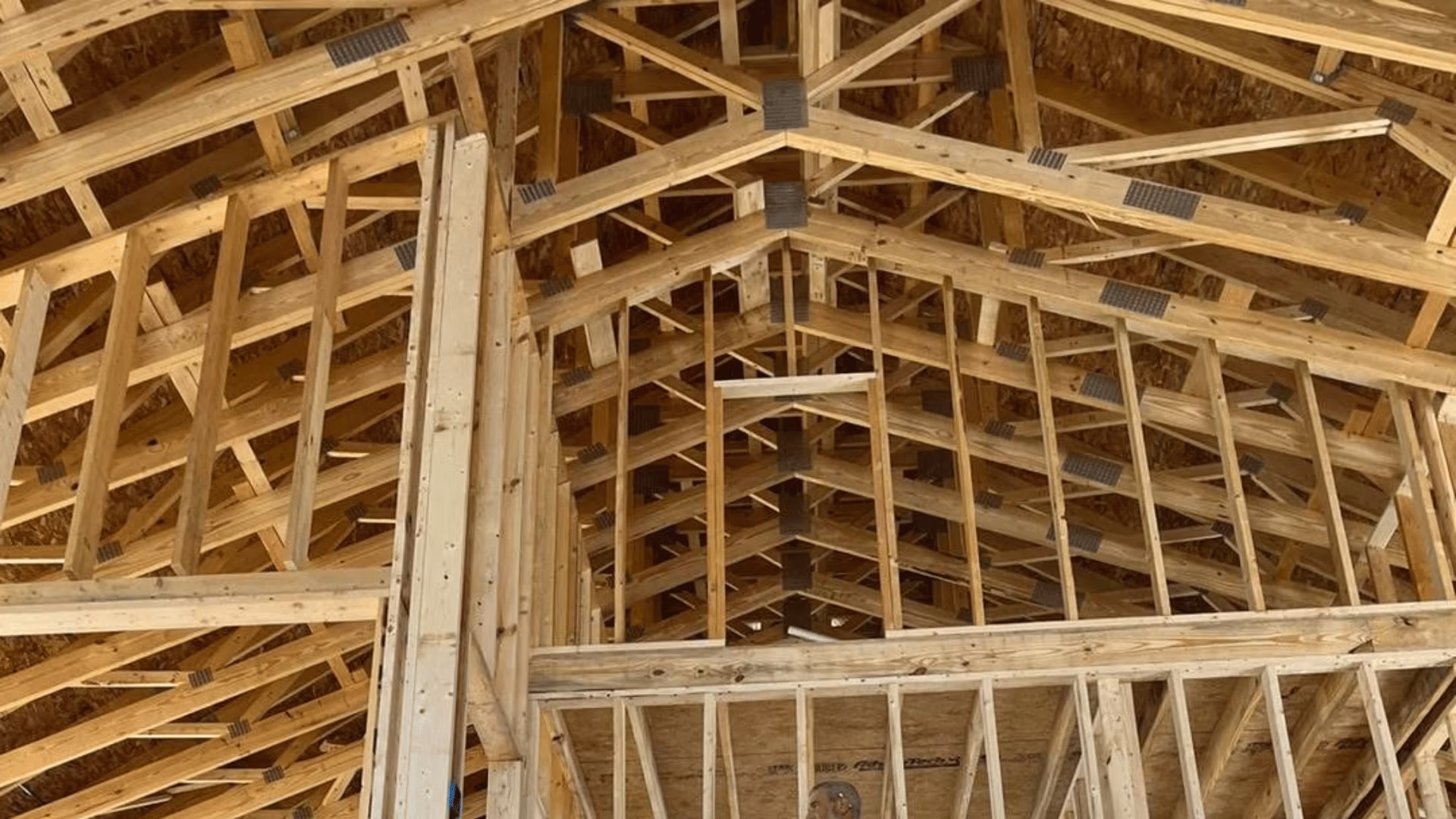 Wood roof trusses and framing inside a house under construction