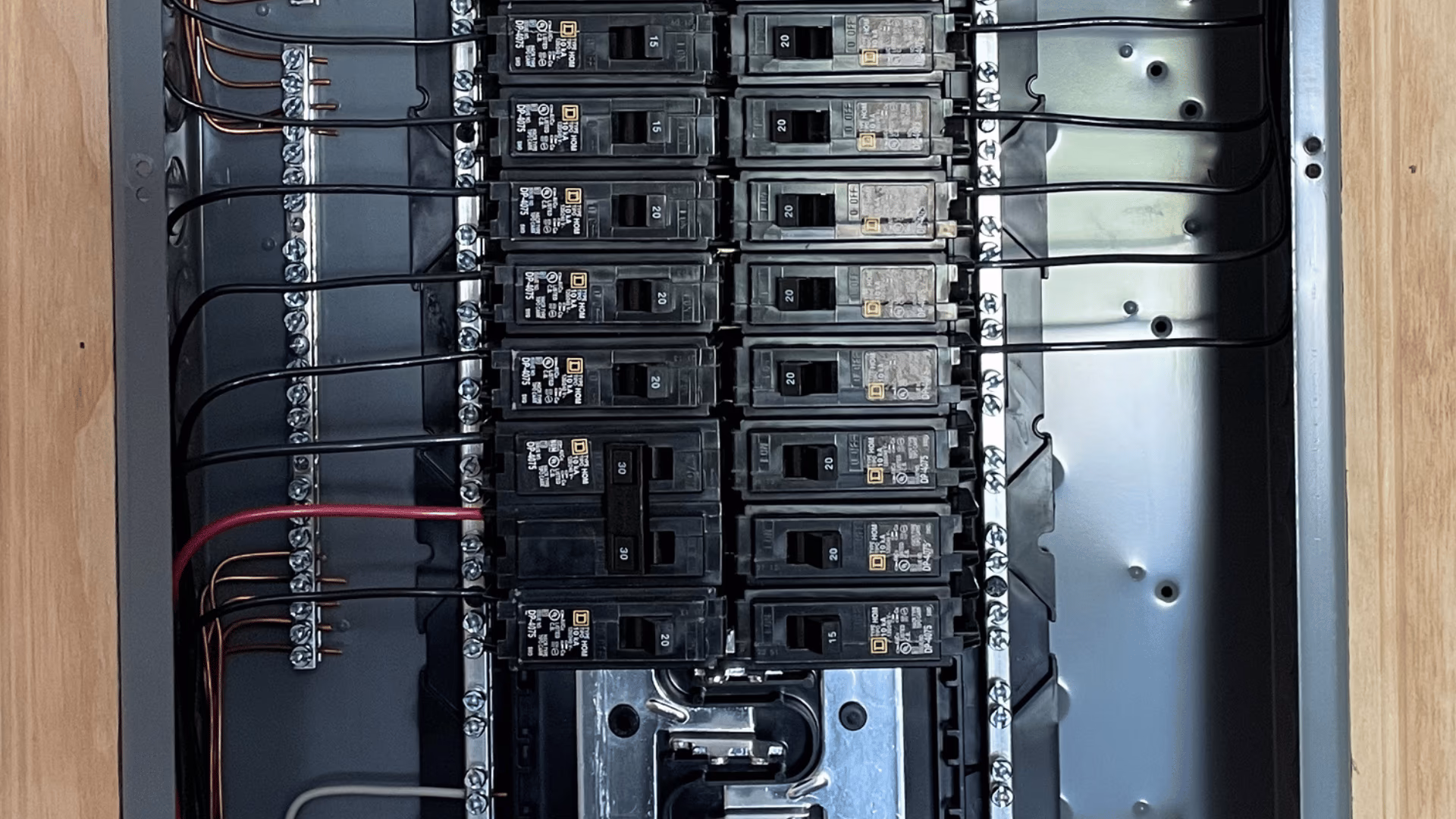 Open residential breaker panel with labeled circuits