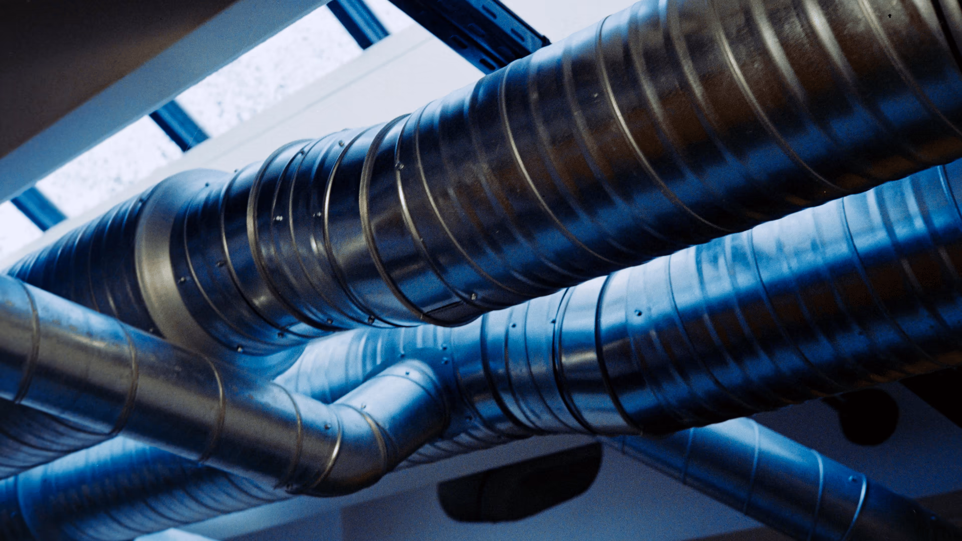 Metal HVAC ductwork running along a ceiling