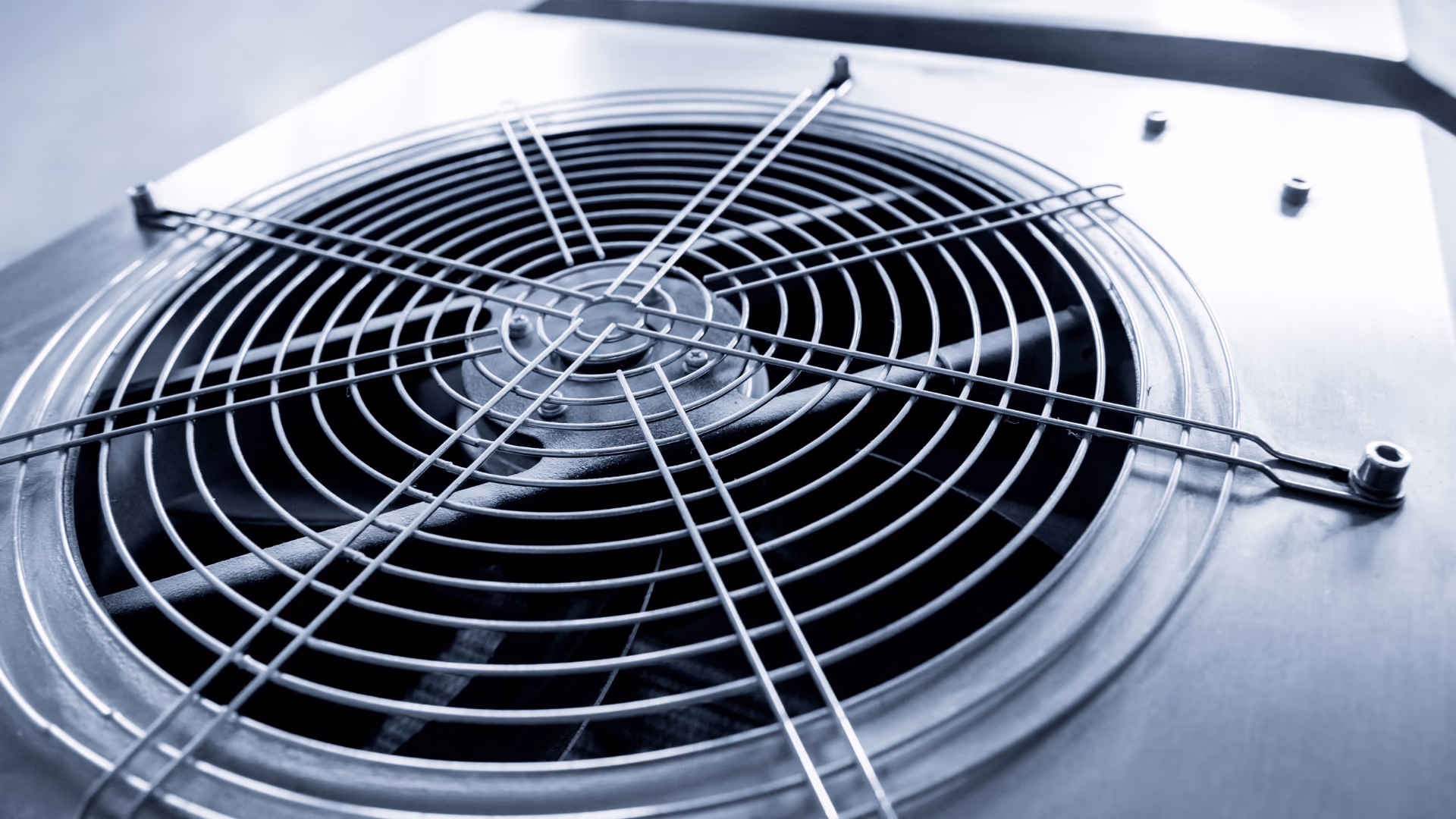 Close-up of an outdoor air conditioner fan grille