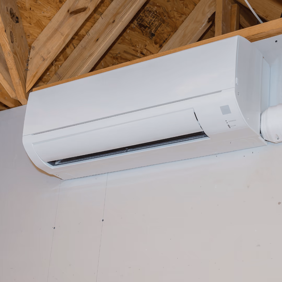 Wall-mounted ductless mini-split under exposed ceiling joists