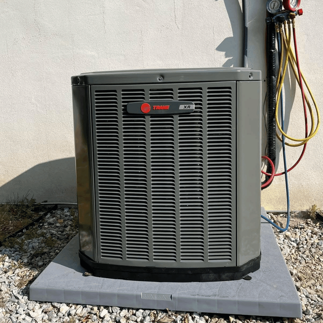 Outdoor air conditioner beside a home