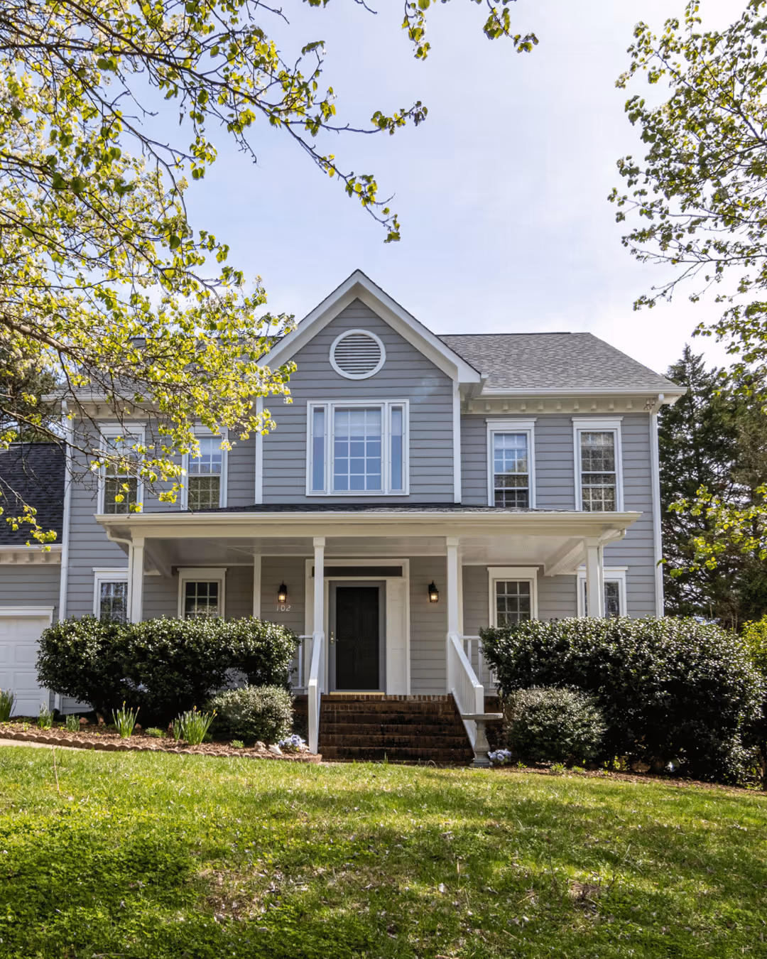 Two-story gray home with a covered front porch