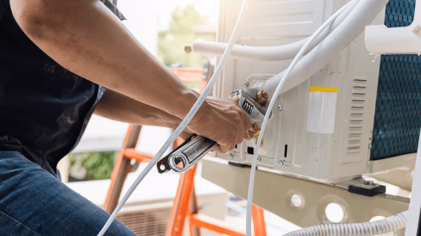 Technician mounting a new outdoor cooling unit